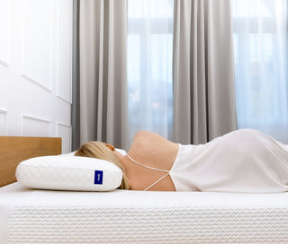 Frau liegt nachts wach im Bett und kann nicht schlafen